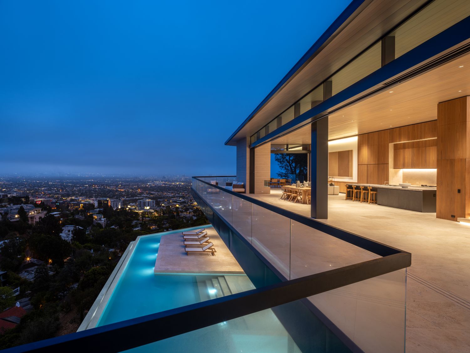 Minimal frame sliding door system with ultra-thin profiles in luxury hillside residence