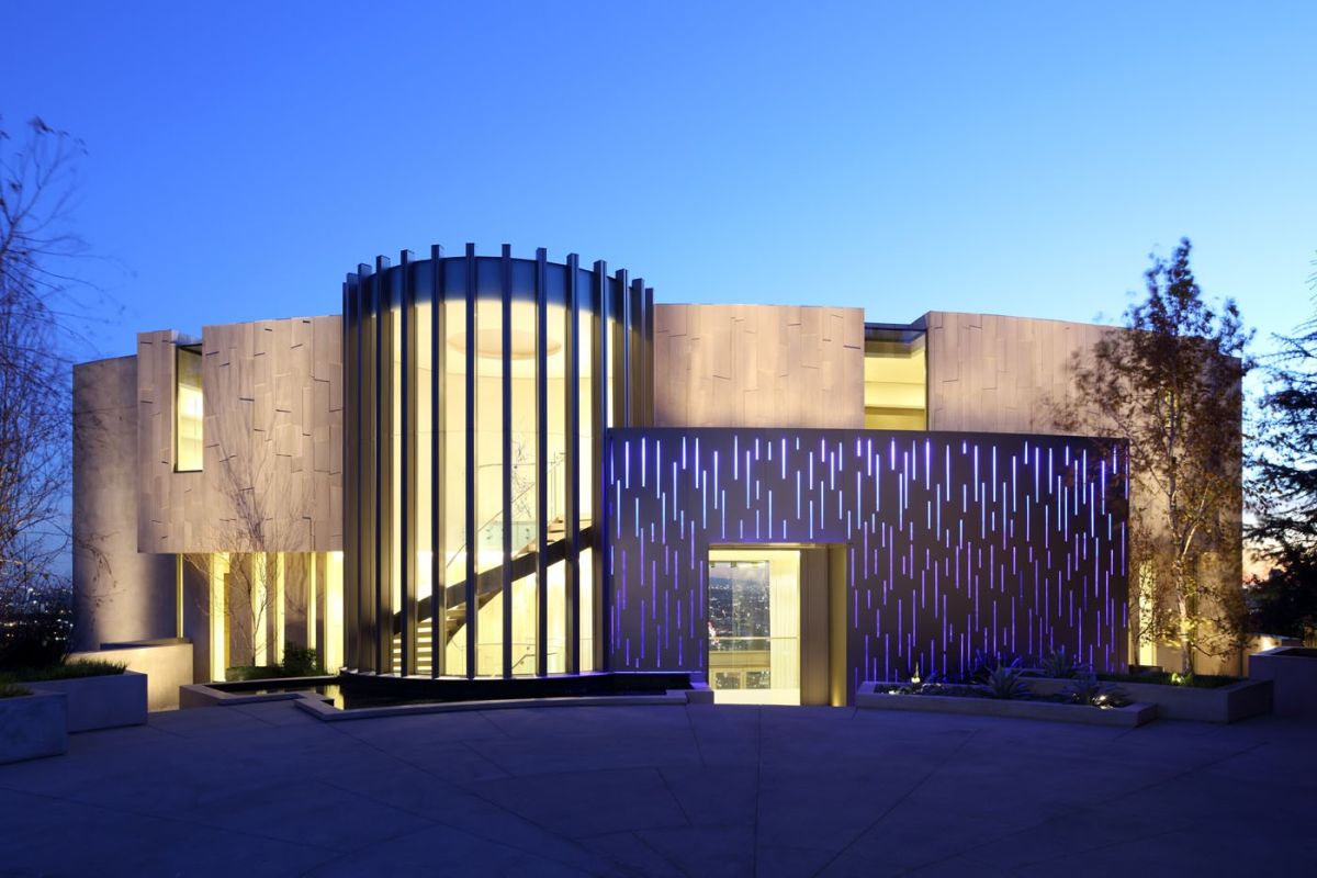 Curved curtain wall facade with vertical mullions at twilight