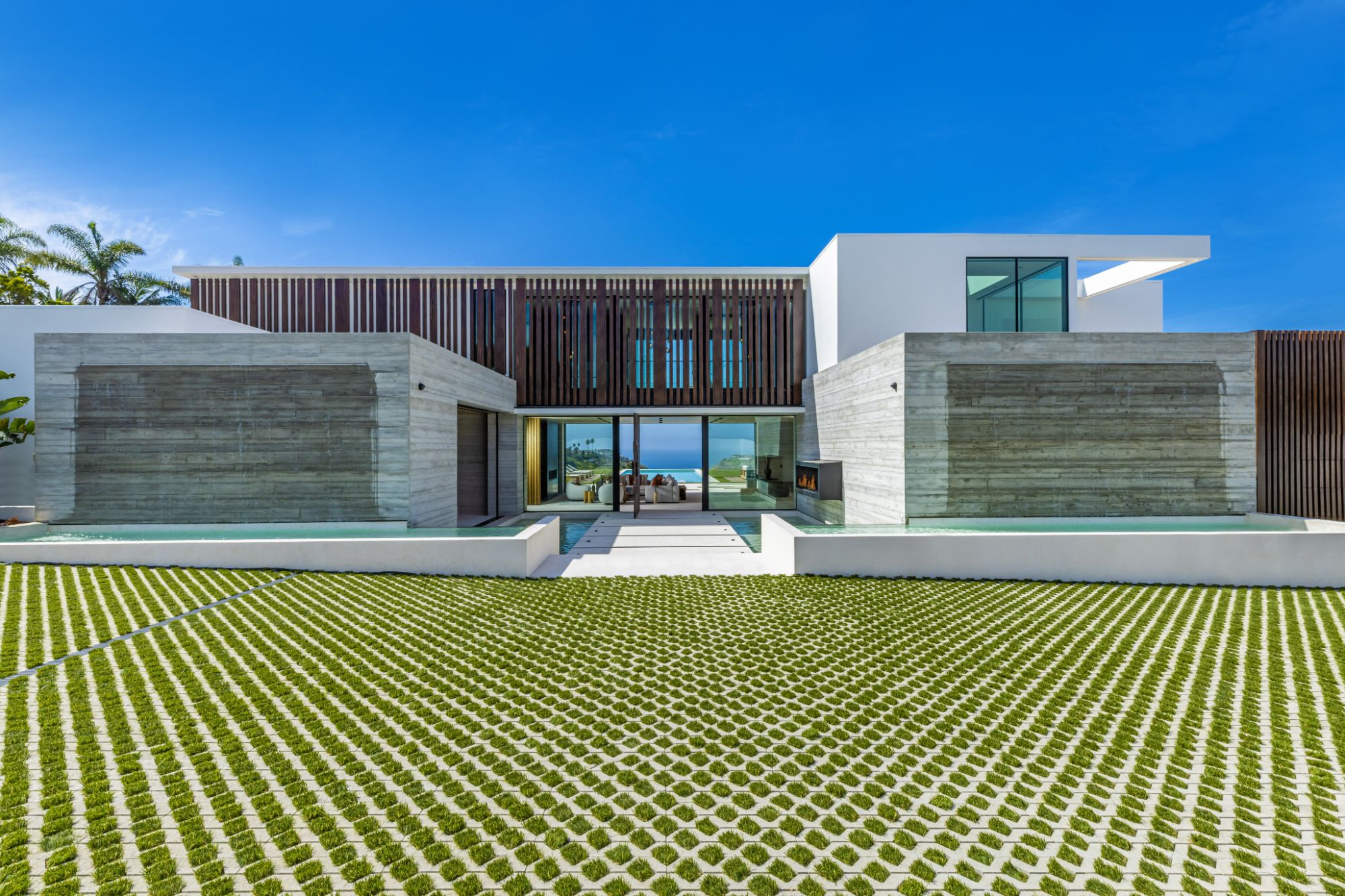 Luxury coastal home with Styline minimal frame glass walls and natural landscape
