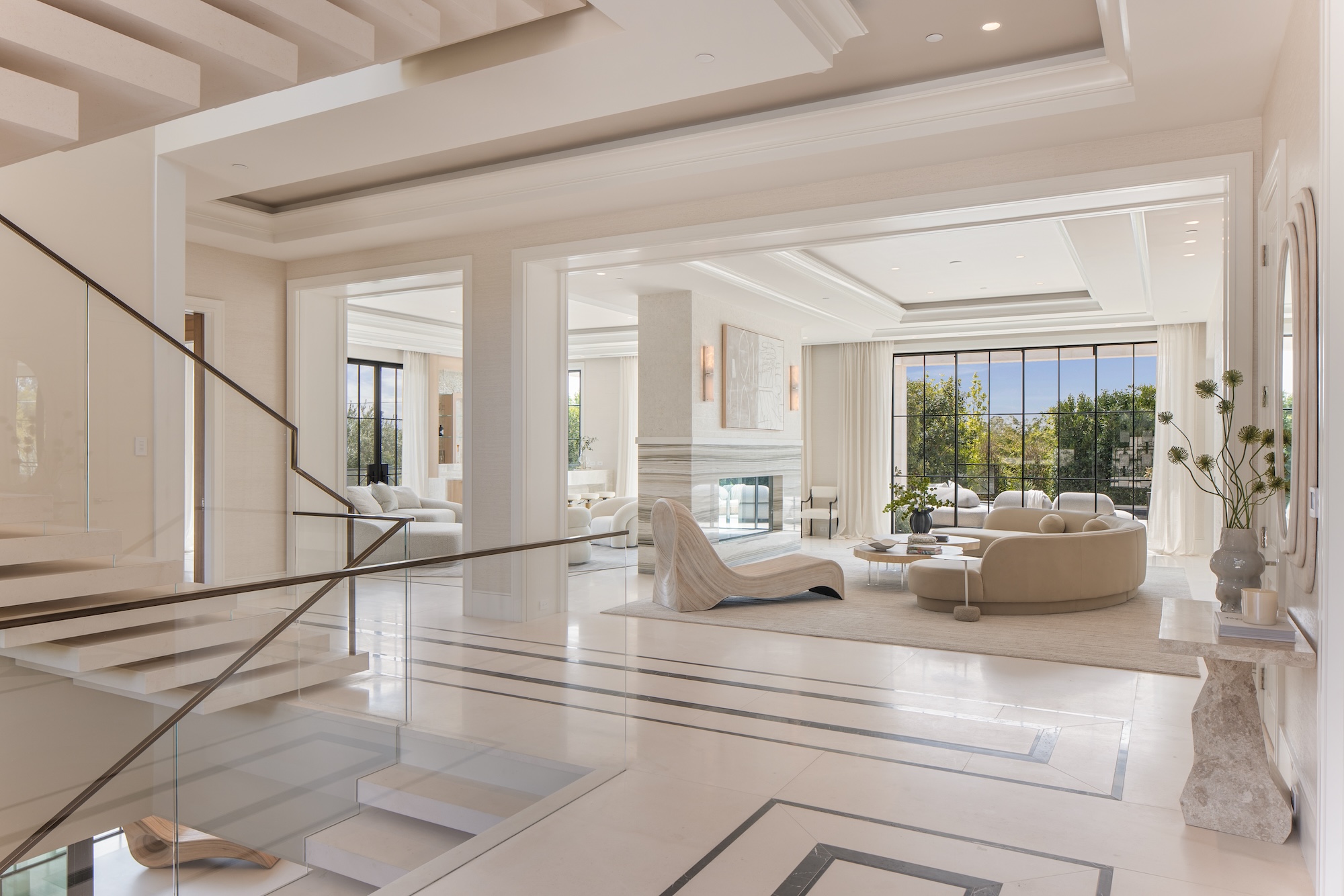Grand white interior with Steel Essence™ steel-look windows — coffered ceilings and marble floors with grid-pattern fenestration