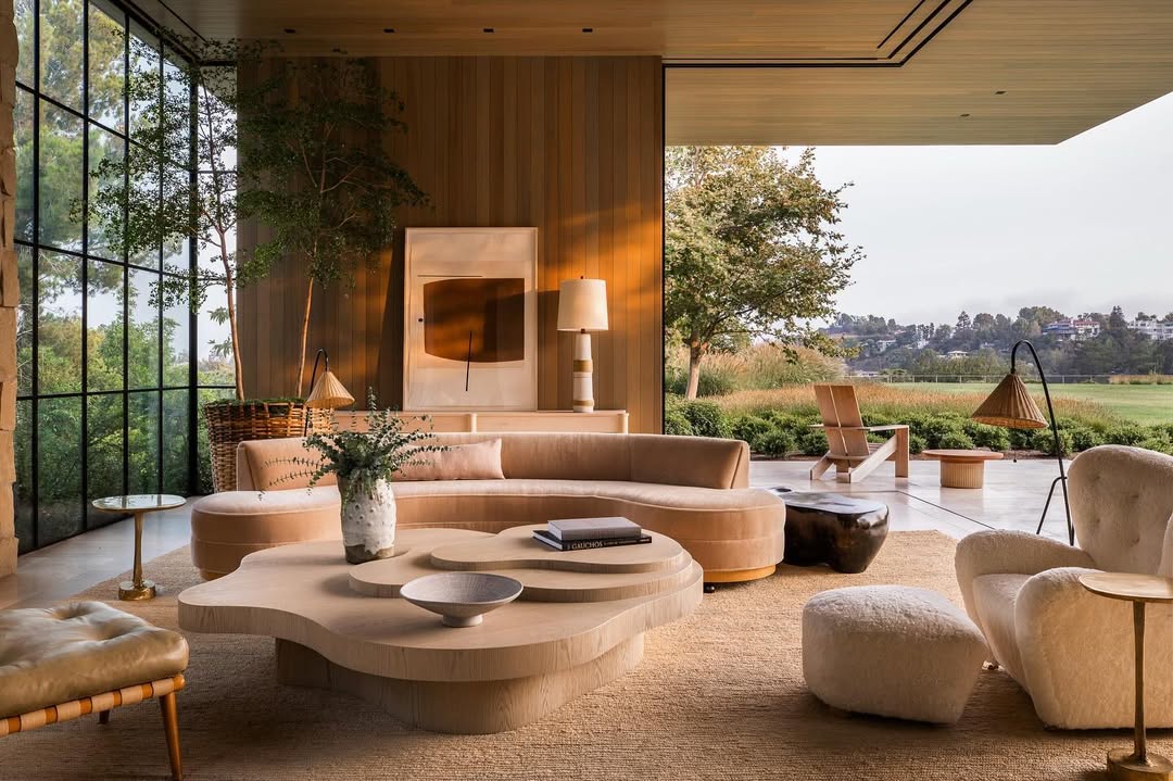 Luxury living room with floor-to-ceiling Steel Essence™ steel-look windows overlooking a garden landscape