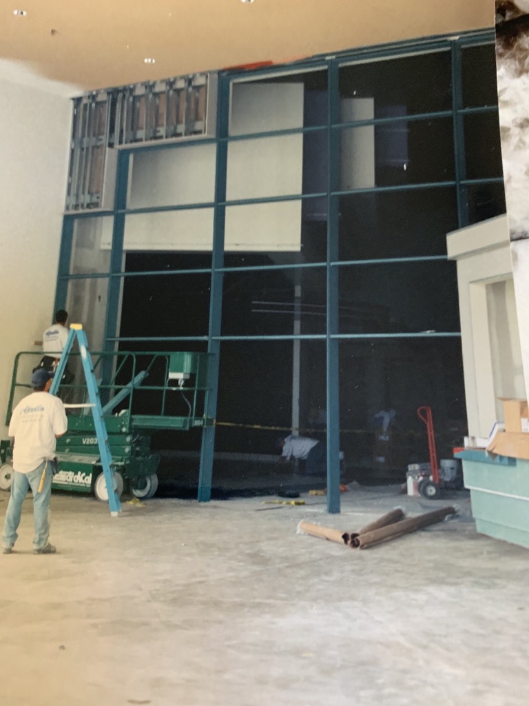 Glaziers installing a tall curtain wall system on an early project